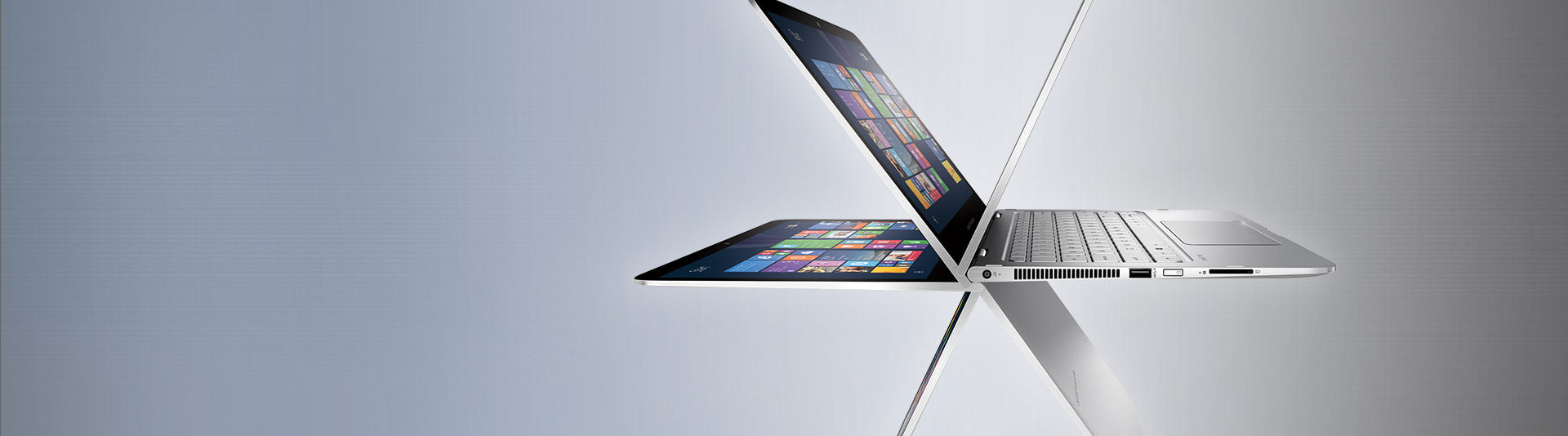 Open laptop displaying colorful screen on a reflective surface with gradient background